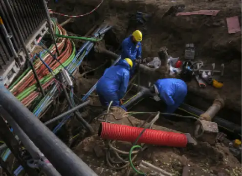 Field workers in safety clothing working on underground electrical infrastructure (1)
