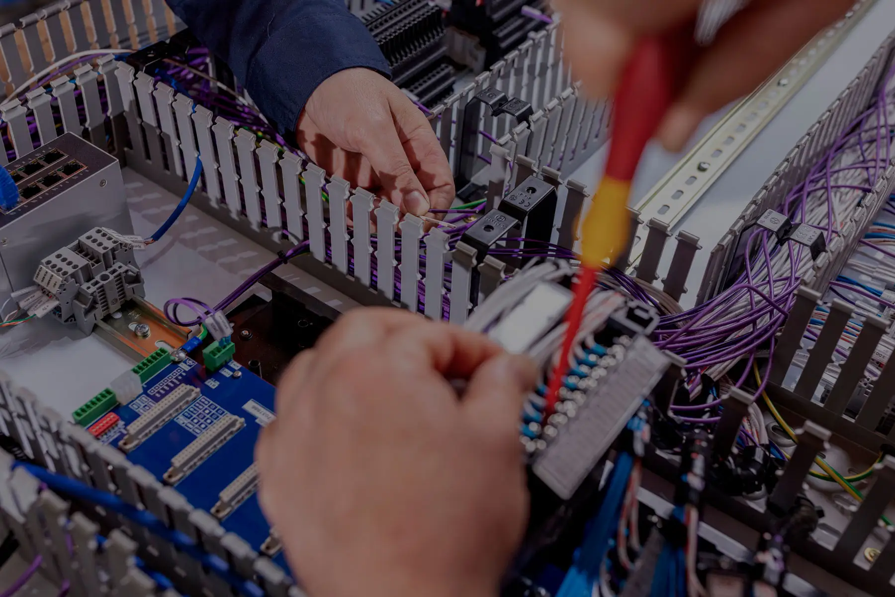 electricians installing or fixing the wires a switchboard